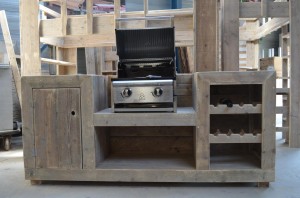 Buitenkeuken met een grill, het keukenblok is gemaakt van steigerhout.